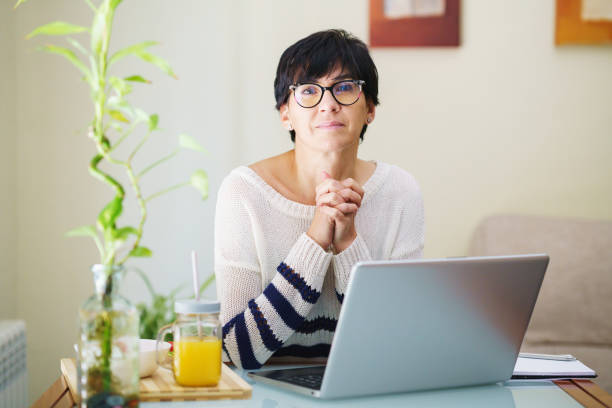 istock Woman teleworking from home with her laptop. 1422272781