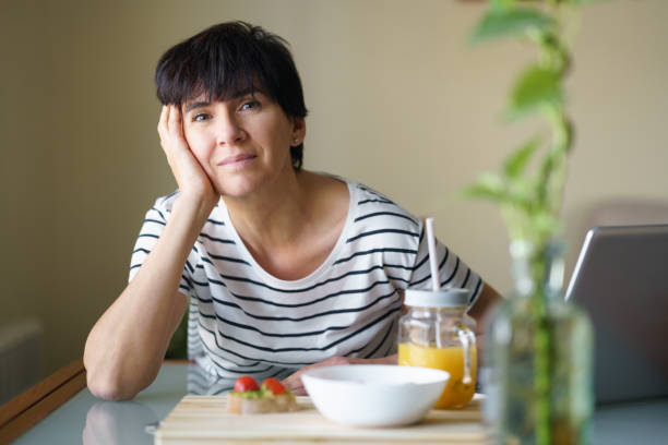 istock Self-confident looking woman, happy and relaxed looking at the camera on a break from her work. 1422272800