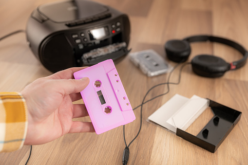 Pink cassette tape with audio equipment