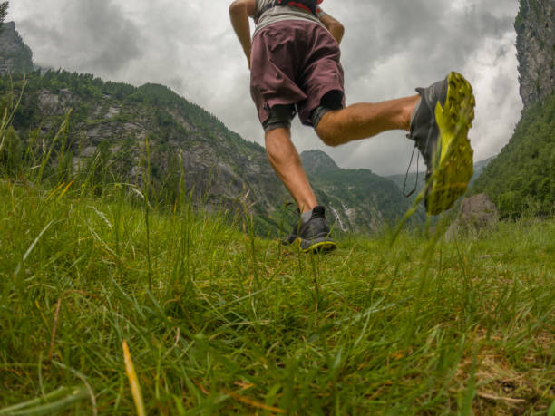 istock Man trail runs along mountain trail 1422272948