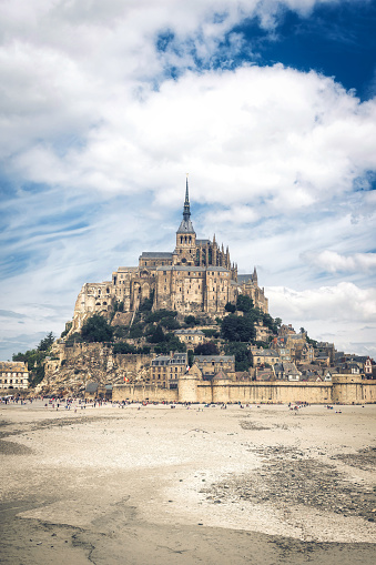 low angle view on the monastery of Mont Saint Michel on cloudy day