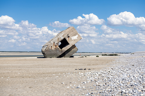 german bunker at beach of Hourdel in France at low tide on sunny summer day