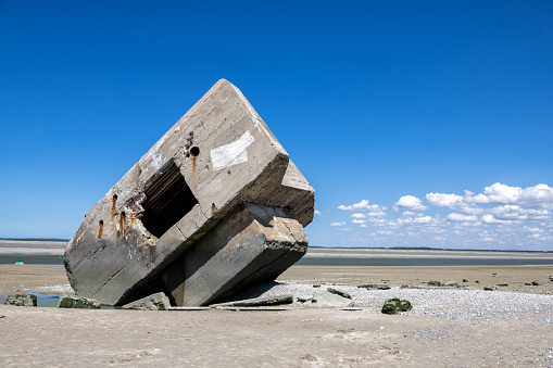 german bunker at beach of Hourdel in France at low tide on sunny summer day