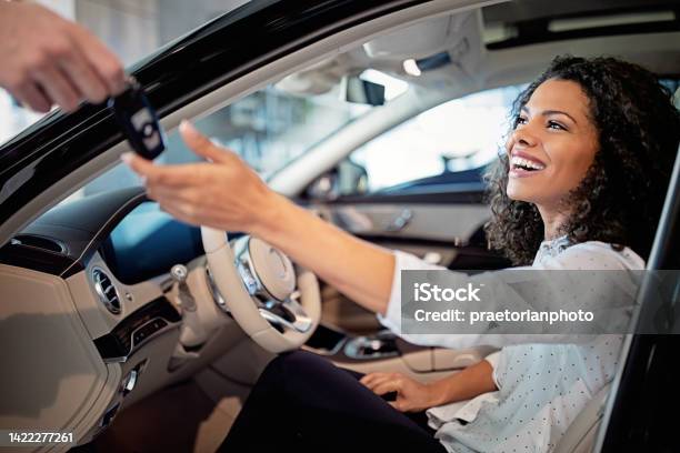Car Dealer Is Giving Key For A New Car To A Woman Stock Photo - Download Image Now - Car Ownership, Car Rental, Car Dealership
