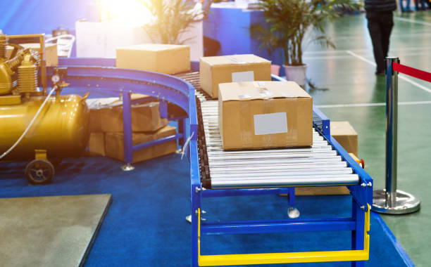 istock Package boxes on the industrial conveyor line 1422277507