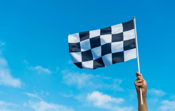istock Hand holding checkered race flag in the air 1422277550