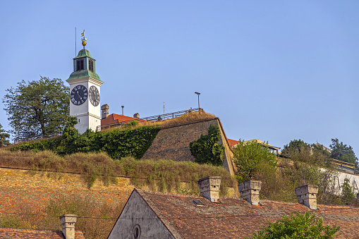 Novi Sad, Serbia - August 19, 2022: Clock Tower at Petrovaradin Fortress Summer Day.