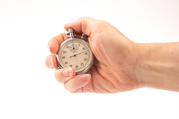 istock hand with a mechanical analog stopwatch on a white background. Time part precision. Measurement of the speed interval 1422279185