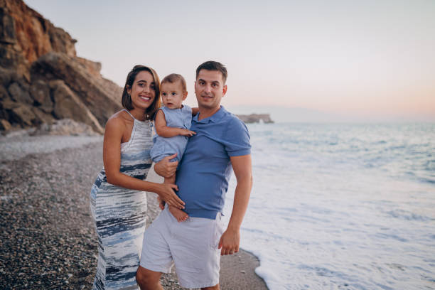 istock Family holding hands on beach 1422279735
