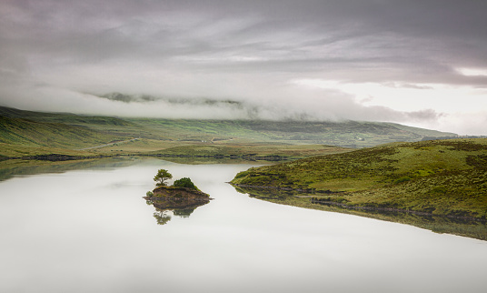 Amazing view over Scotlands Highlands Loch Fada lake with mountains, valleys and with dramatic heavy clouds