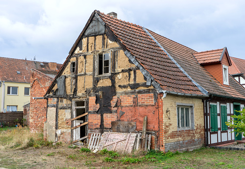 An old, desolate half-timbered house is abandoned and uninhabited.