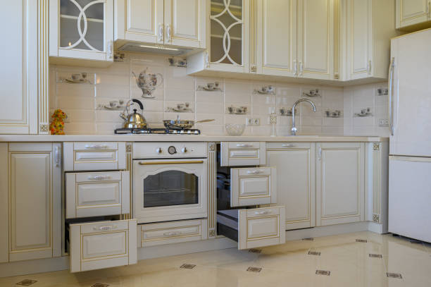 istock Classic white and beige kitchen furniture in studio apartment 1422287112