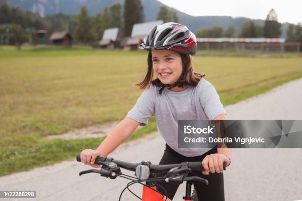 Smiling Teenage Girl Cycling And Wearing A Helmet Stock Photo - Download Image Now - Cycling Helmet, Happiness, Teenager