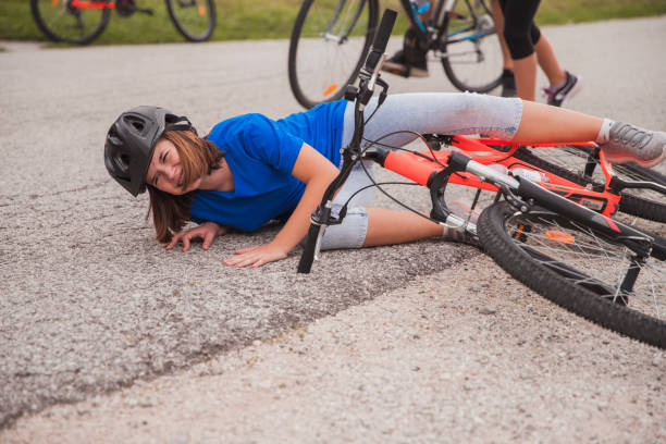 istock Girl wearing helmet when falling from bicycle 1422288345