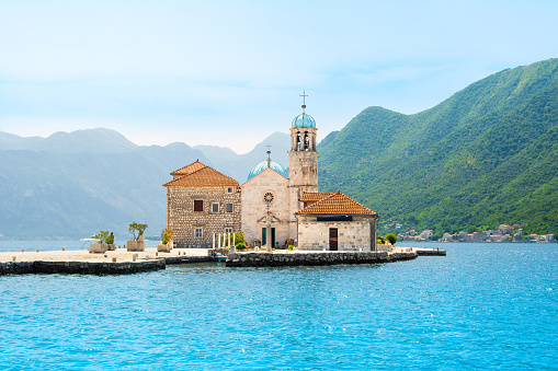 Sunset  landscape of the Bay of Kotor coastline - Boka Bay with view to the Roman Catholic Church of Our Lady of the Rocks on the island, Montenegro