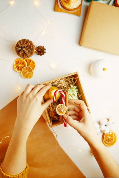 istock Woman is packing Christmas gift. 1422294273