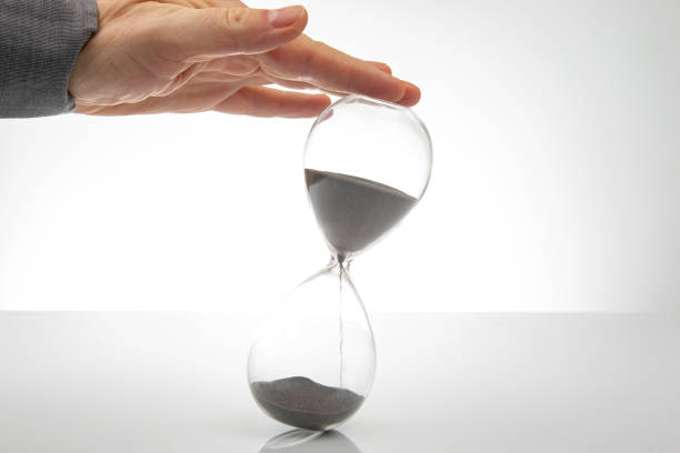 istock Hourglass on a light background. Time is money. Business solutions in time. 1422294845