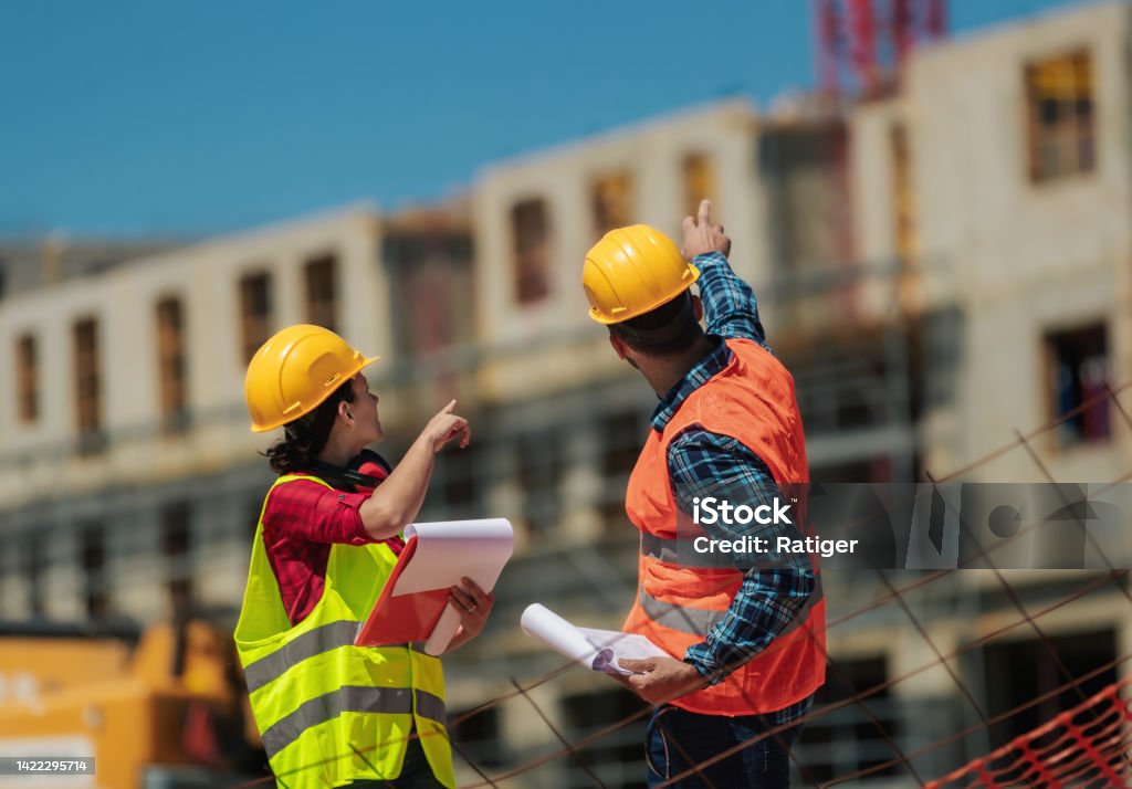 Workers On Construction Site Pointing Towards Observed Problems In workers-on-construction-site-pointing-towards-observed-problems-in