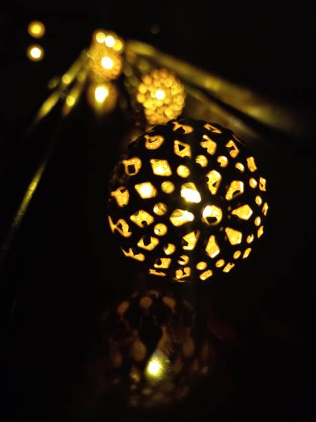 istock Closeup of light bulbs, illuminating the dark. 1422295956