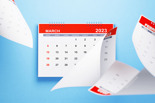 2023 March calendar laying on blue background. Horizontal composition with copy space. Directly above. Calendar and reminder concept.