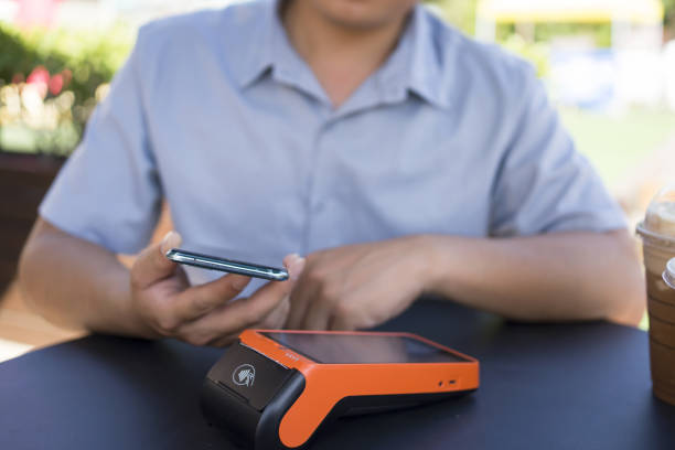 istock Asian man making contactless mobile payment 1422299669
