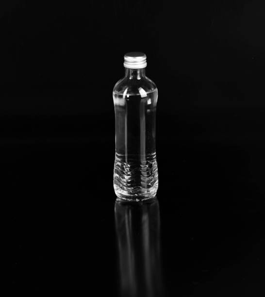 istock glass bottle with mineral water isolated on black background 1422302790