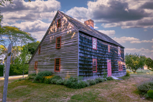 Concord, Massachusetts, August 35, 2019.  A man dressed up in a period costume playing the flute at the historic Colonel James Barrett House and Farm within the Minute man national park in Concord Massachusetts.