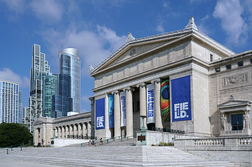 Chicago, USA - August 2022:  The classical architecture of the Field Museum of Natural History contrasts against the modern style of nearby skyscrapers