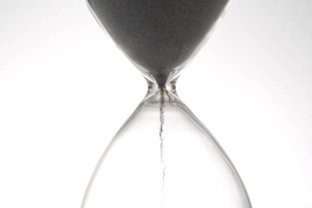 istock Hourglass on a light background. Time is money. Business solutions in time. 1422311791