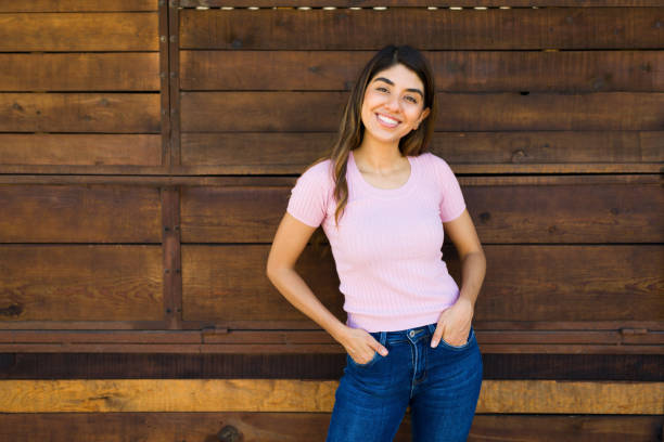 istock Hispanic beautiful woman looking happy standing against a wall 1422311947