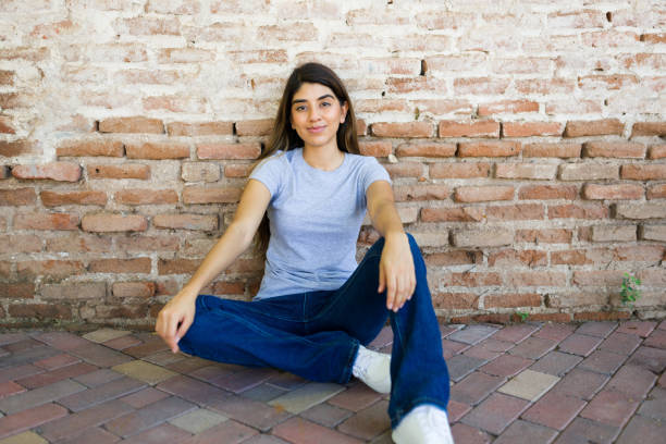 Free Stock Photo of Young woman sitting on a sloped concrete wall ...