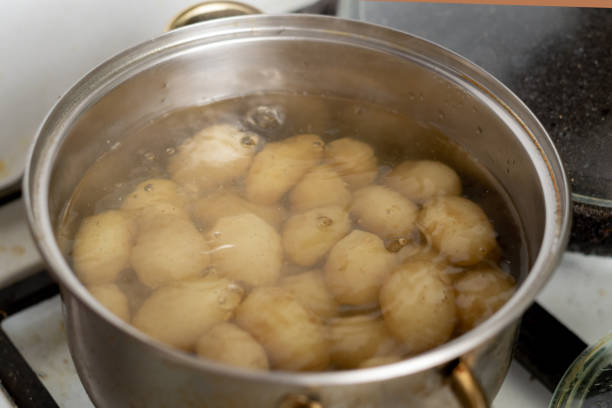 istock Potatoes boiling in a saucepan. Cooking young potatoes. 1422317481