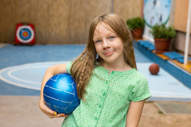 Portrait of young Caucasian girl playing with a ball Portrait of active young 7 year's old Caucasian girl playing with ball cleft lip stock pictures, royalty-free photos & images