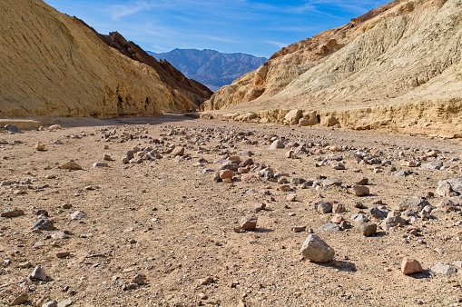 Dry wash in desolation canyon, Death Valley national park, California. Golden hued sedimentary rocks from an ancient sea bed color this canyon.