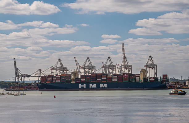 HMM container ship handled at terminal, Southampton, England, UK stock photo