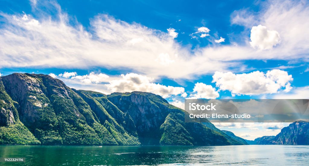 Travel concept. Amazing nature view with beautiful clouds above the fjord. Location: Lysefjorden, Norway, Europe. Artistic picture. Beauty world. Panorama Travel concept. Amazing nature view with beautiful clouds above the fjord. Location: Lysefjorden, Norway, Europe. Artistic picture. Beauty world. Mountain Stock Photo