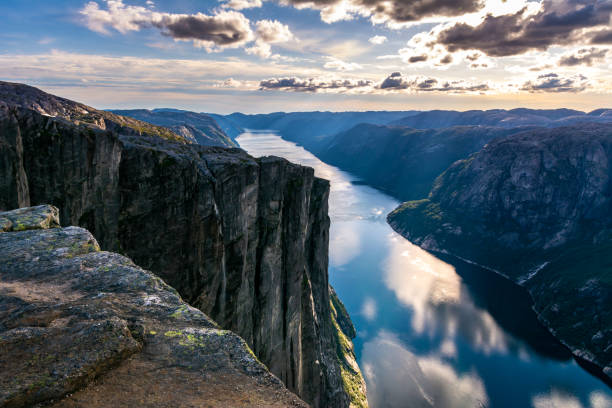 majestic view of the lysefjorden, with mountains on the sunset. the mountain kjerag in forsand municipality in rogaland county, norway. - lake mountain range mountain deep imagens e fotografias de stock
