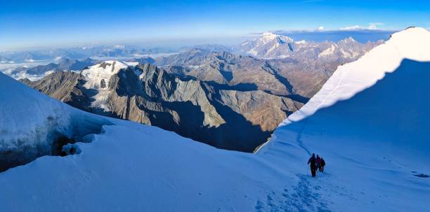 istock Summit ascent between combin de valsorey and combin de grafeneire on the grand combin massif. walk over glaciers. Path tracks in the snow, Valais alps. High quality photo 1422325354