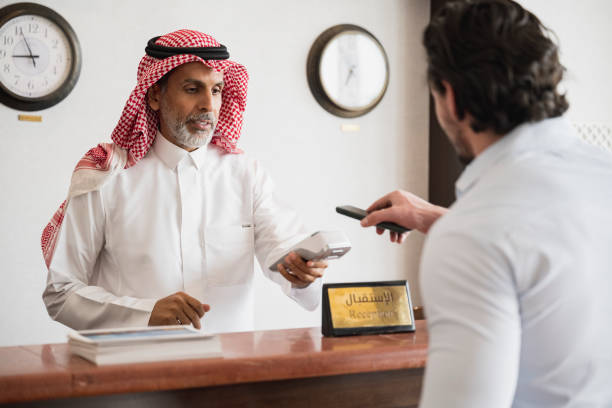istock Traveller making contactless payment at hotel reception desk 1422327423