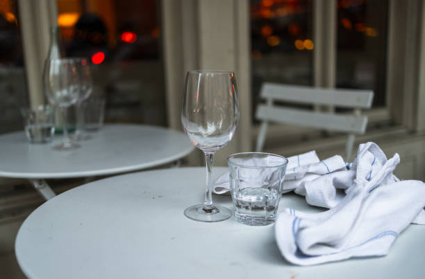 Glasses and napkins left on the cafe table before cleaning.