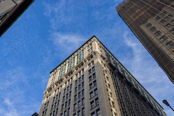 istock Buildings exterior up from below with blue sky at the backdrop. 1422328768