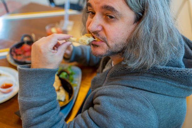 istock Hungry man having dinner in the sidewalk cafe. 1422328780