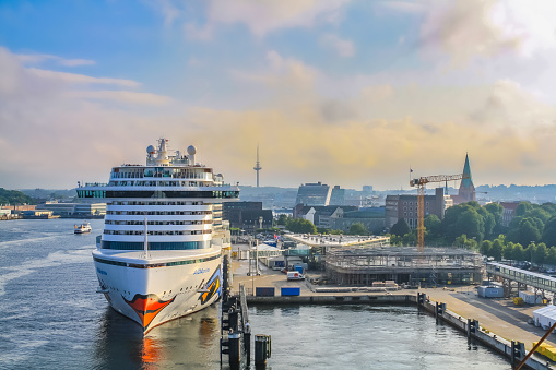 Kiel, Germany - August, 2019: Beautiful cloudscape at Kiel Harbor with the AIDA Prima docked here, getting ready to leave port.