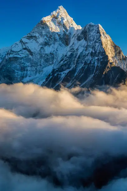 55MPix XXXXL size panorama of Mount Ama Dablam - probably the most beautiful peak in Himalayas. 
 This panoramic landscape is an very high resolution multi-frame composite and is suitable for large scale printing
Ama Dablam is a mountain in the Himalaya range of eastern Nepal. The main peak is 6,812  metres, the lower western peak is 5,563 metres. Ama Dablam means  'Mother's neclace'; the long ridges on each side like the arms of a mother (ama) protecting  her child, and the hanging glacier thought of as the dablam, the traditional double-pendant  containing pictures of the gods, worn by Sherpa women. For several days, Ama Dablam dominates  the eastern sky for anyone trekking to Mount Everest basecamp