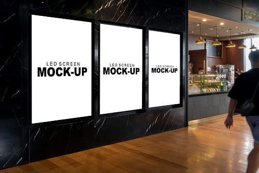 Mockup three advertising LED Screen Install on marble wall of coffee shop with clipping path, empty space for insert your text, announcement, multi-media content and advertisement in shopping mall
