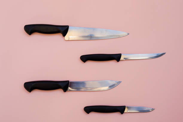 istock knives on pink background 1422346305