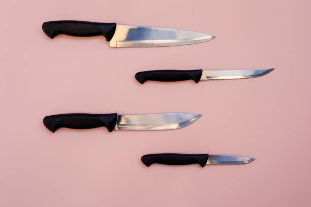 istock knives on pink background 1422346317