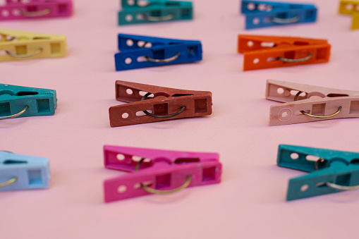 clothespins on pink background