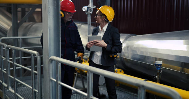 istock During negotiations with a heating plant worker, the manager holds a digital tablet in her hands. 1422347120