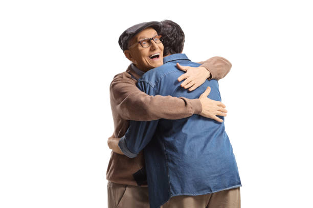 istock Happy elderly man embracing a young man and smiling 1422359238